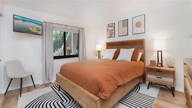 a bedroom with a bed and a lamp on table