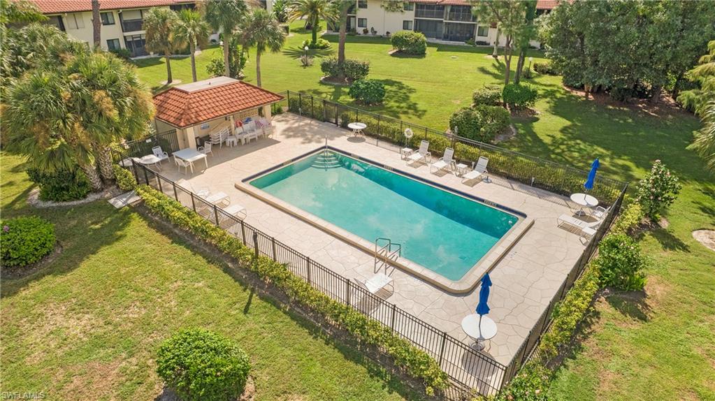 4957 Pepper Circle, Unit C104 Naples, FL 34113 - Photo 17 of 22 an aerial view of a house with a garden and swimming pool