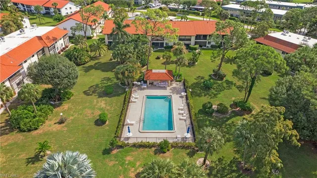 an aerial view of residential houses with outdoor space and street view
