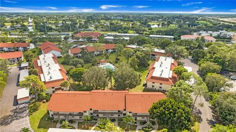 an aerial view of residential houses with outdoor space and street view