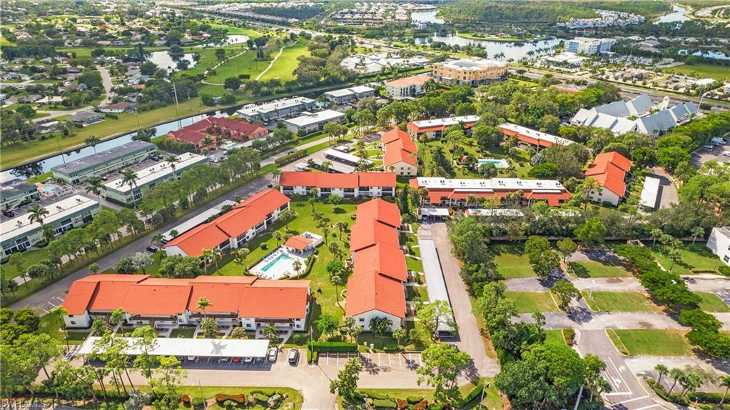 4957 Pepper Circle, Unit C104 Naples, FL 34113 - Photo 20 of 22 an aerial view of residential houses with outdoor space and street view