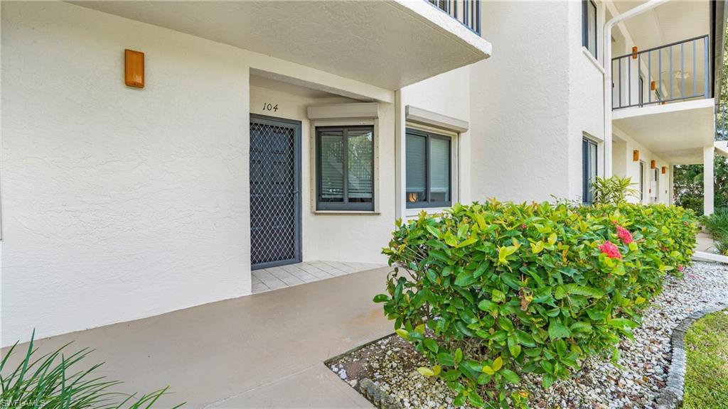 4957 Pepper Circle, Unit C104 Naples, FL 34113 - Photo 21 of 22 front view of a house with a yard