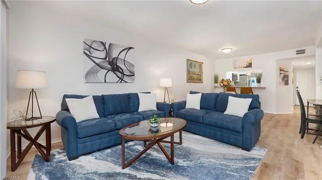 a living room with furniture and a lamp