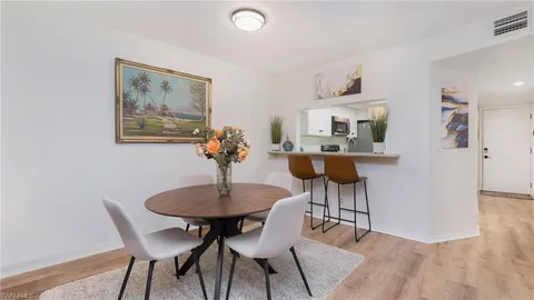 a dining room with furniture and wooden floor