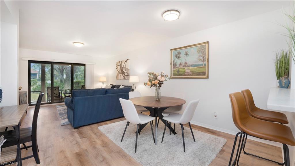 4957 Pepper Circle, Unit C104 Naples, FL 34113 - Photo 8 of 22 a dining room with furniture and window