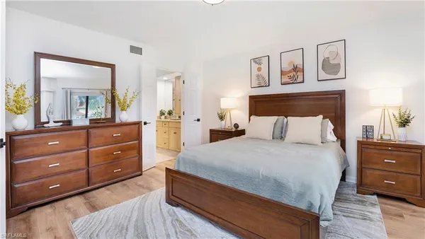 a bedroom with a bed and a dresser