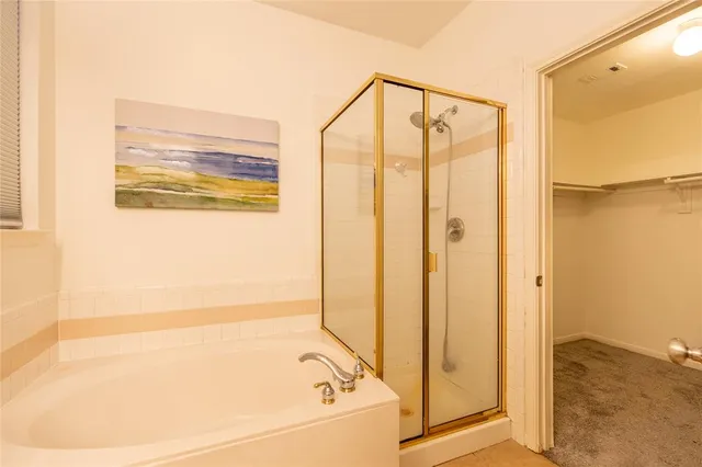 a bathroom with a bathtub and a shower