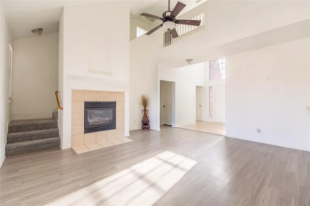 a view of a livingroom with wooden floor and a fireplace