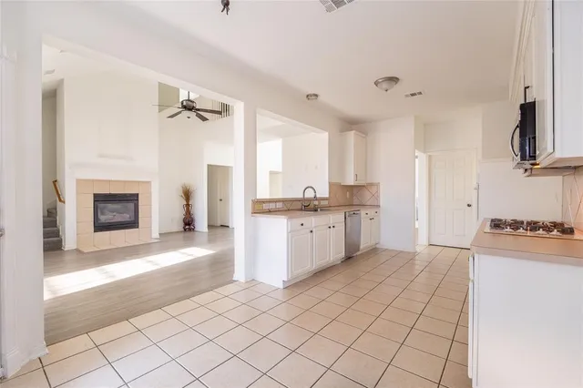 a kitchen with a cabinets and a stove top oven