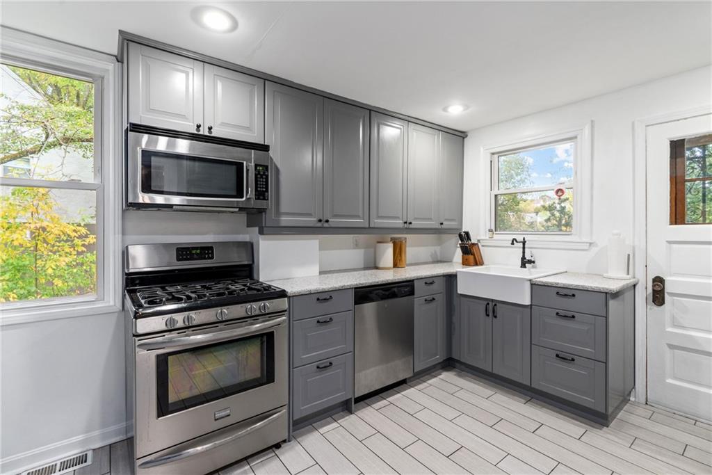 27 North Park Road Pittsburgh, PA 15229 - Photo 11 of 33 a kitchen with stainless steel appliances granite countertop a stove microwave and sink