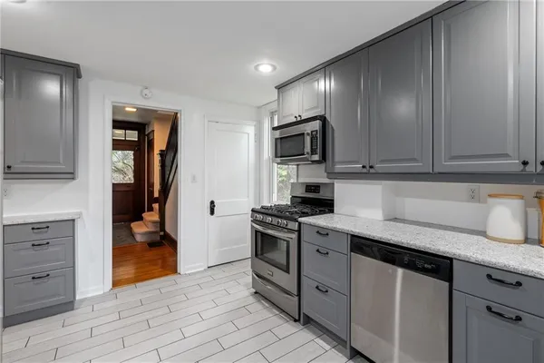 a kitchen with granite countertop stainless steel appliances and cabinets