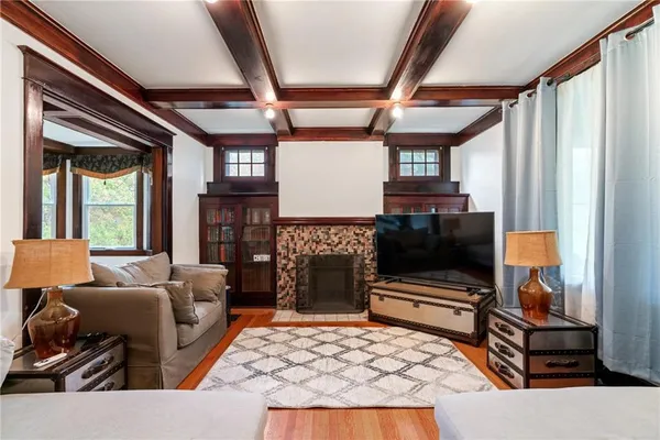 a living room with fireplace furniture and a flat screen tv