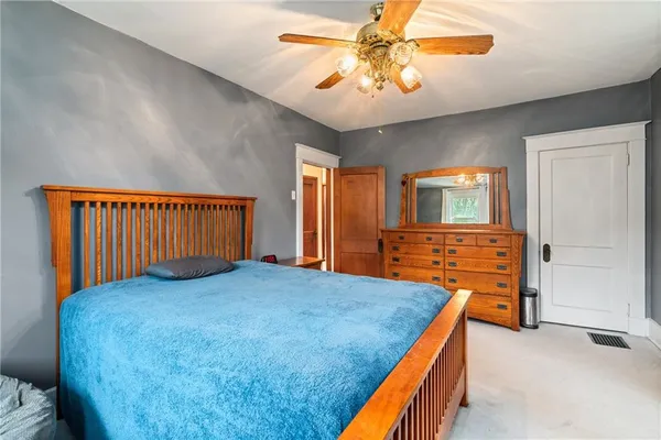 an empty room with closet and flat screen tv