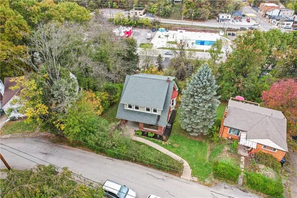 an aerial view of a house with a yard and garden