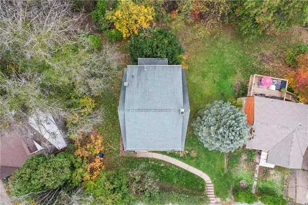 an aerial view of a house with a yard and garden