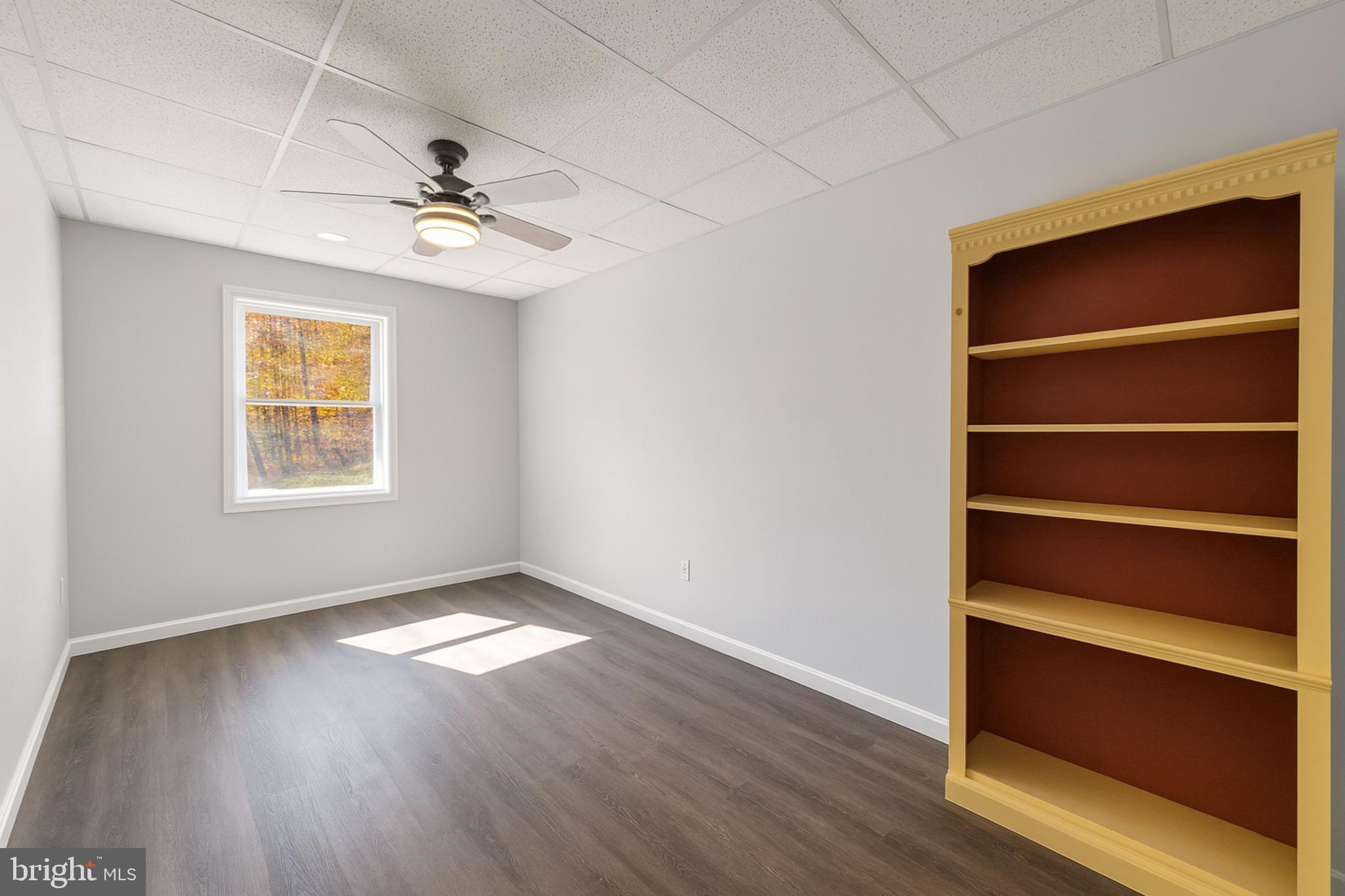 200 Mile Ridge Estates Strasburg, VA 22641 - Photo 14 of 18 a view of an empty room with a window and wooden floor