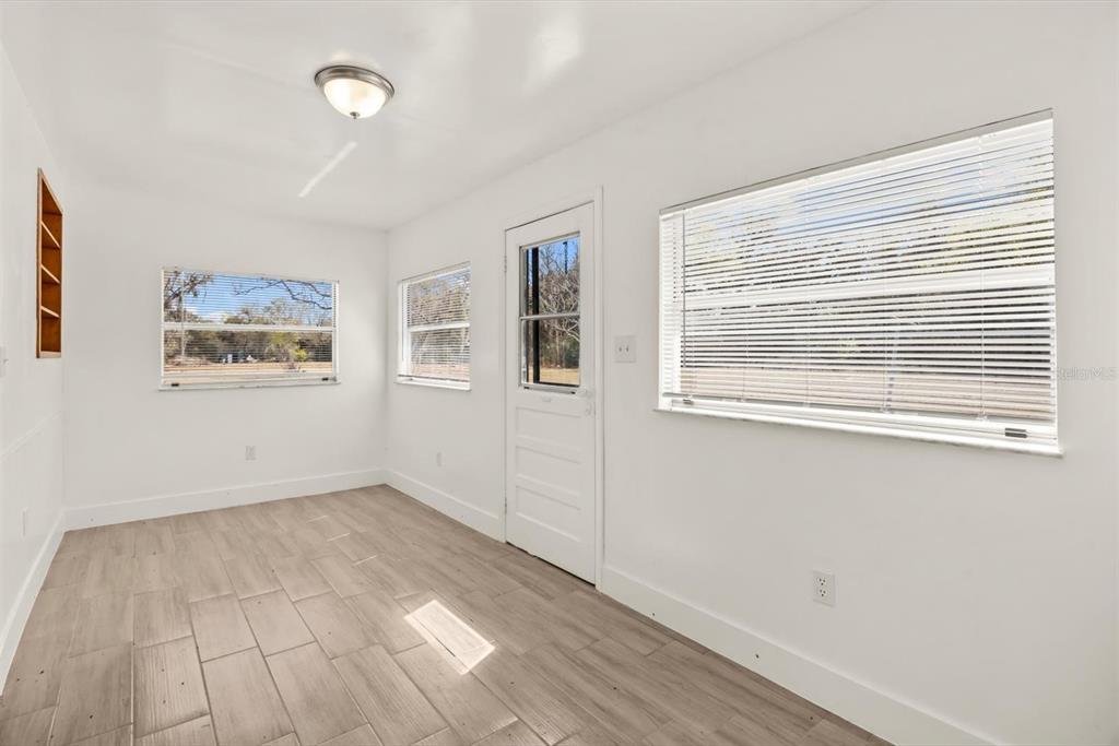 31300 Highway 441 Okeechobee, FL 34972 - Photo 11 of 33 a view of an empty room with window and wooden floor