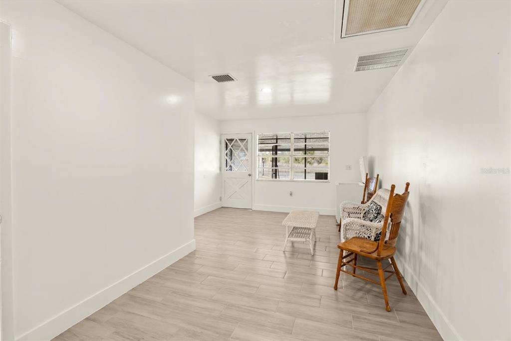 31300 Highway 441 Okeechobee, FL 34972 - Photo 13 of 33 an empty room with wooden floor and windows