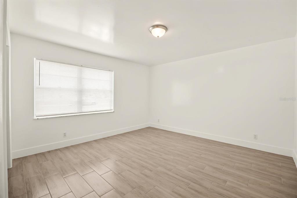31300 Highway 441 Okeechobee, FL 34972 - Photo 15 of 33 an empty room with wooden floor and windows