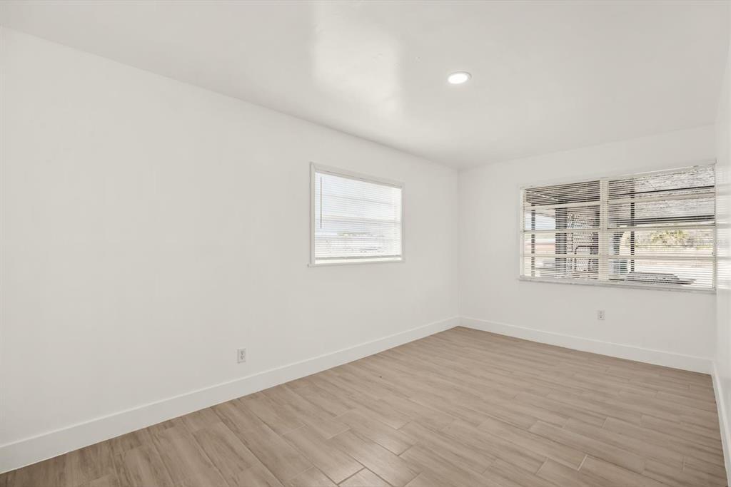 31300 Highway 441 Okeechobee, FL 34972 - Photo 20 of 33 an empty room with wooden floor and windows