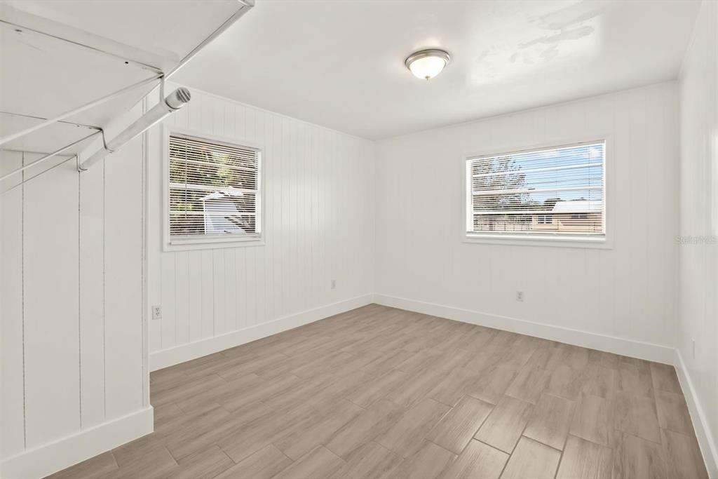 31300 Highway 441 Okeechobee, FL 34972 - Photo 23 of 33 an empty room with wooden floor and windows