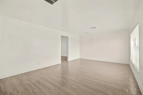 a view of an empty room and glass door