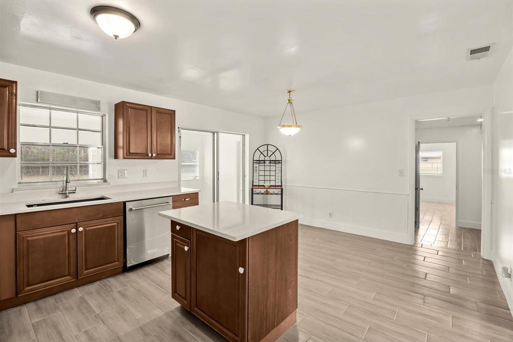 31300 Highway 441 Okeechobee, FL 34972 - Photo 7 of 33 a large kitchen with stainless steel appliances granite countertop a sink and wooden floors
