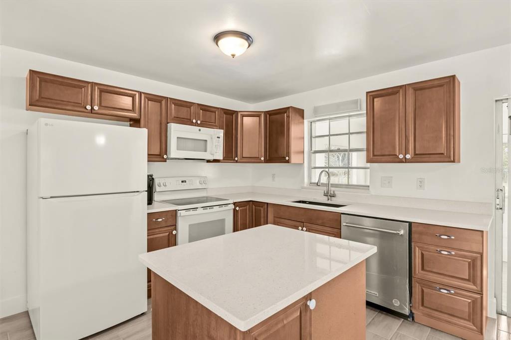31300 Highway 441 Okeechobee, FL 34972 - Photo 9 of 33 a white kitchen with sink stove and refrigerator