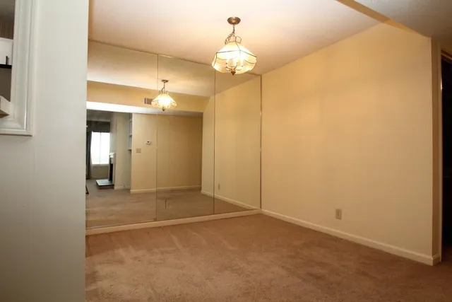 a view of a hallway with a chandelier