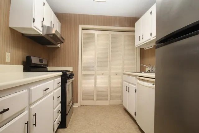 a kitchen with stainless steel appliances a refrigerator and a sink