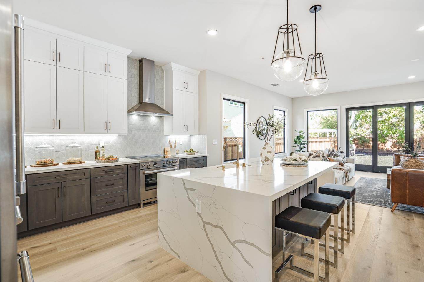 1950 Quito Road San Jose, CA 95130 - Photo 15 of 46 a large kitchen with kitchen island granite countertop a stove a sink a dining table and chairs with wooden floor
