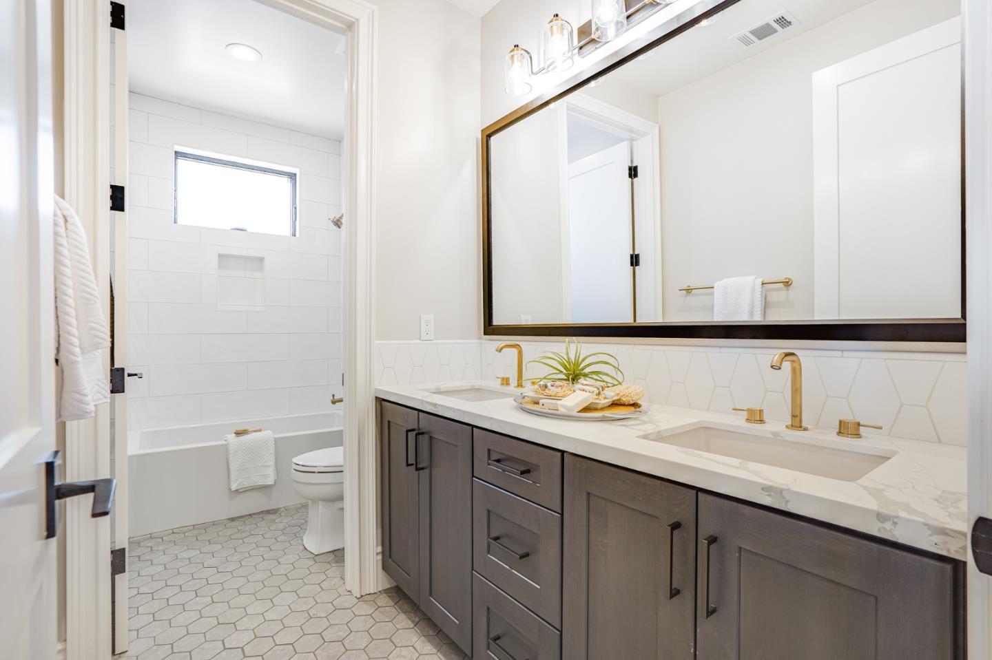 1950 Quito Road San Jose, CA 95130 - Photo 38 of 46 a bathroom with a granite countertop sink a toilet and a mirror