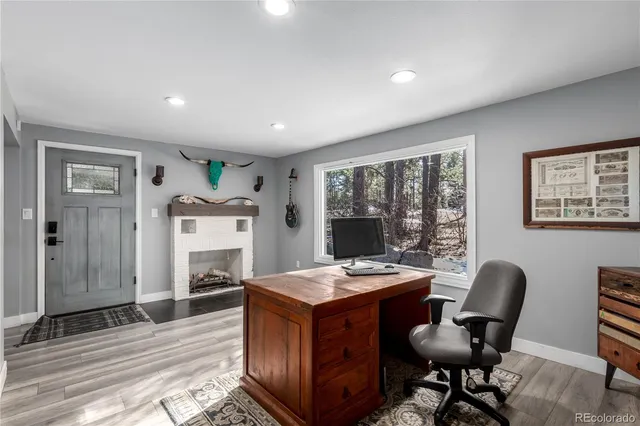 a living room with furniture a flat screen tv and a rug