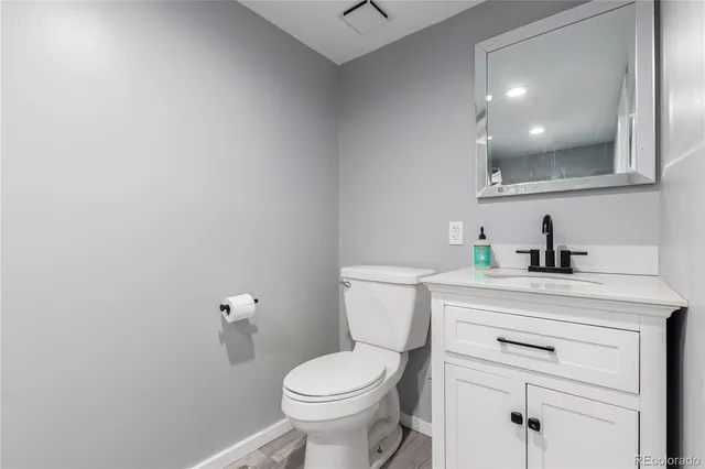 a view of a patio with couches table and chairs with wooden fence