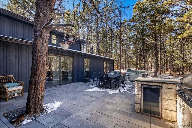 a view of a house with a yard and sitting area