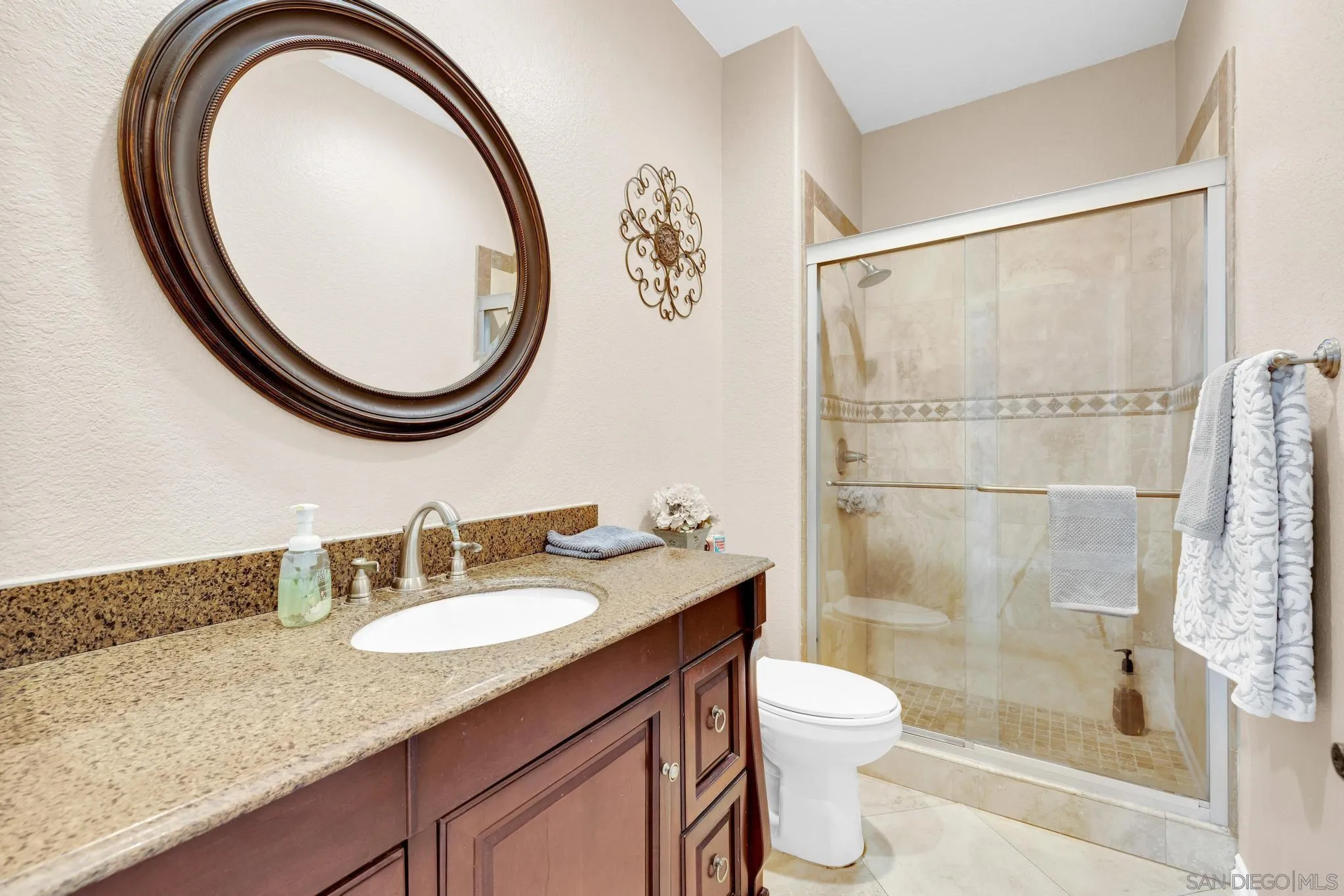 1019 Bremen Way Alpine, CA 91901 - Photo 23 of 68 a bathroom with a granite countertop sink a toilet and a mirror