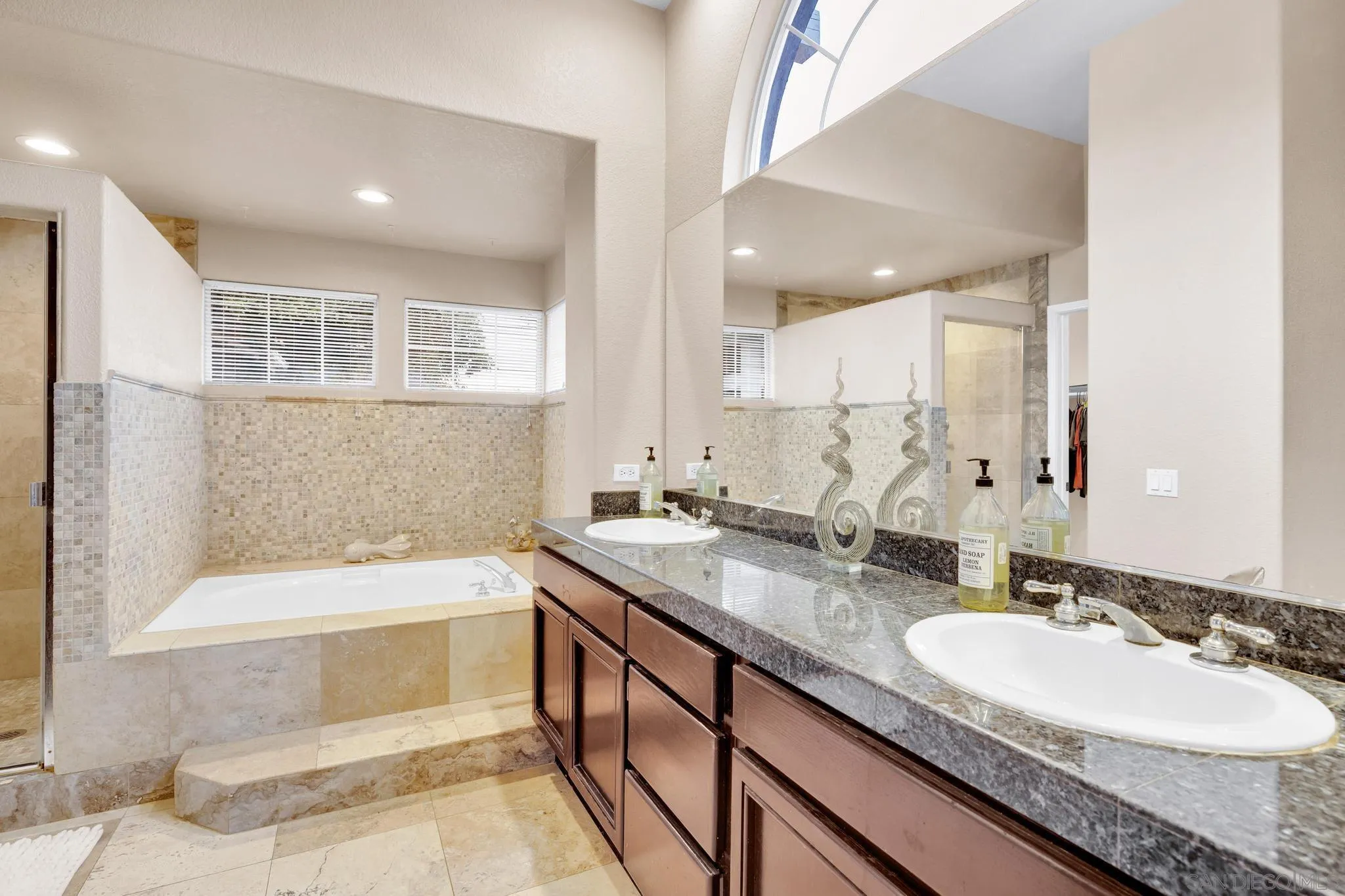1019 Bremen Way Alpine, CA 91901 - Photo 24 of 68 a bathroom with a sink double vanity granite tub shower and a mirror