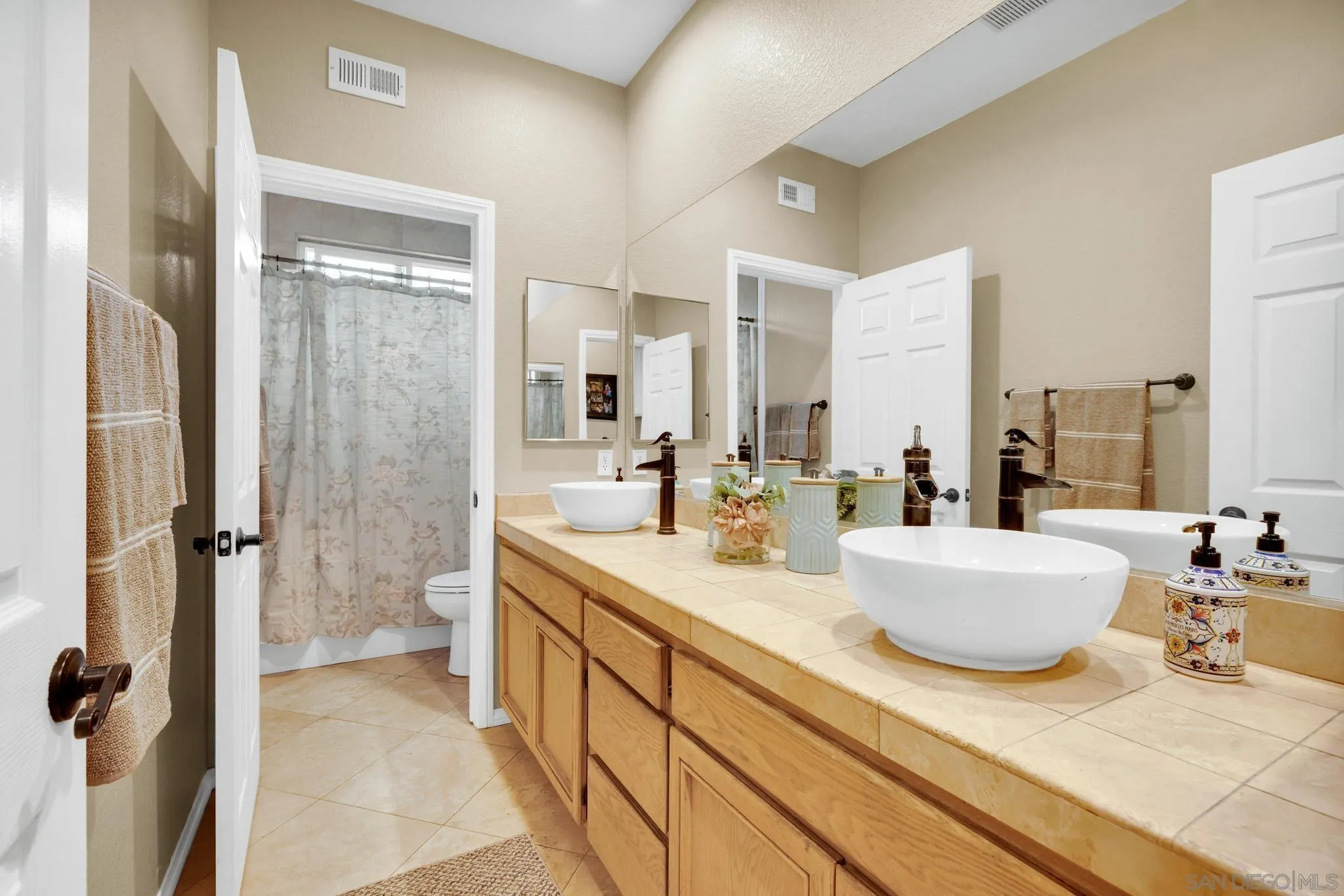 1019 Bremen Way Alpine, CA 91901 - Photo 27 of 68 a spacious bathroom with a double vanity sink a mirror and a shower