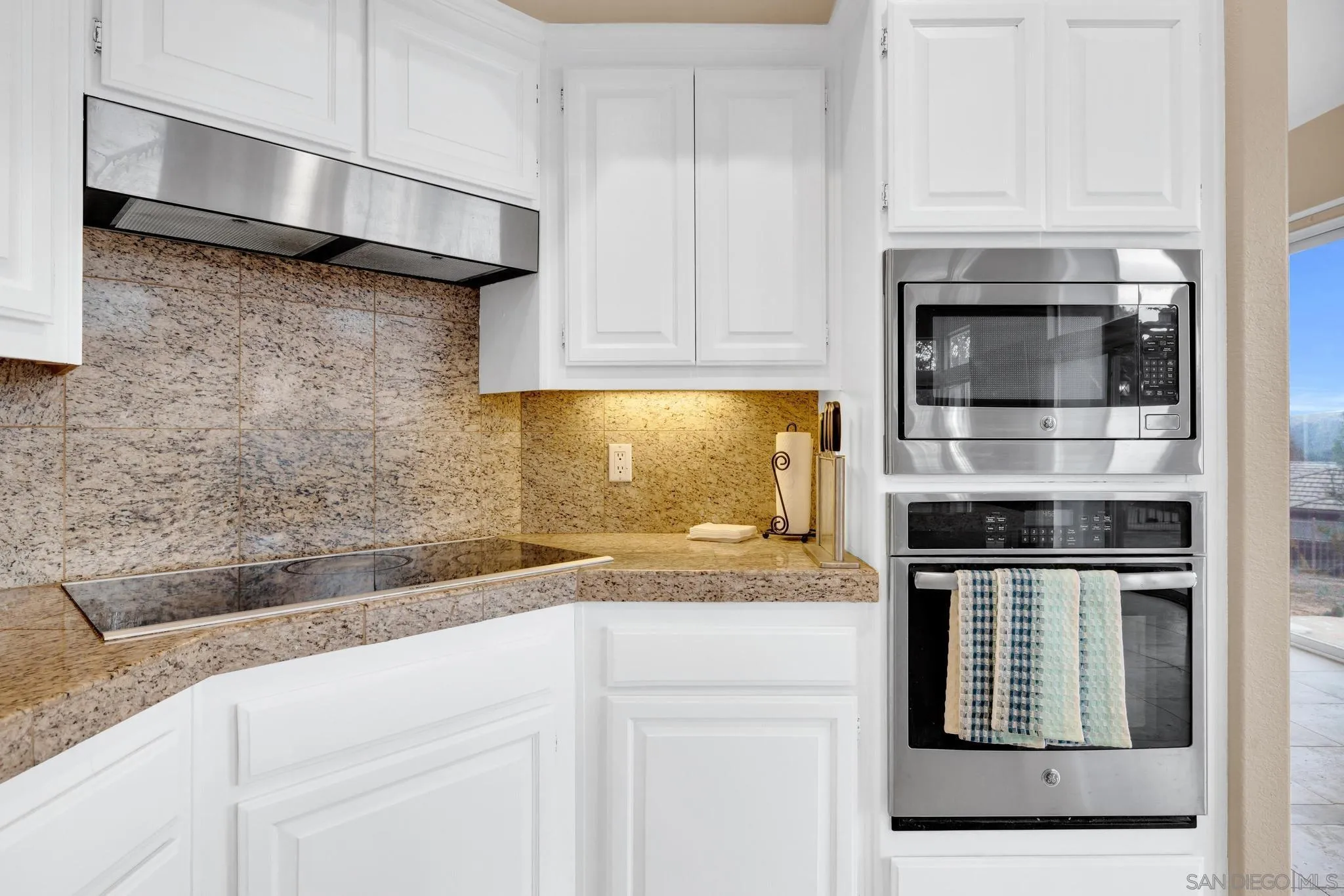 1019 Bremen Way Alpine, CA 91901 - Photo 10 of 68 a kitchen with granite countertop white cabinets and stainless steel appliances