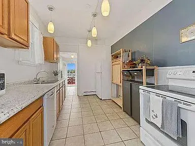 a kitchen with a stove a sink and a refrigerator