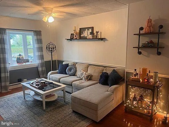 a living room with furniture a rug and a window