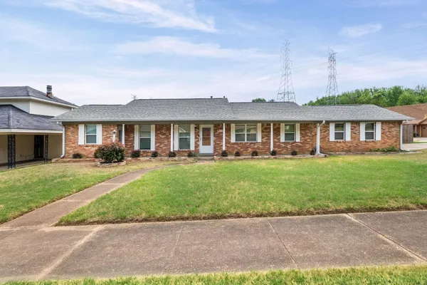 a front view of a house with a yard table and chairs