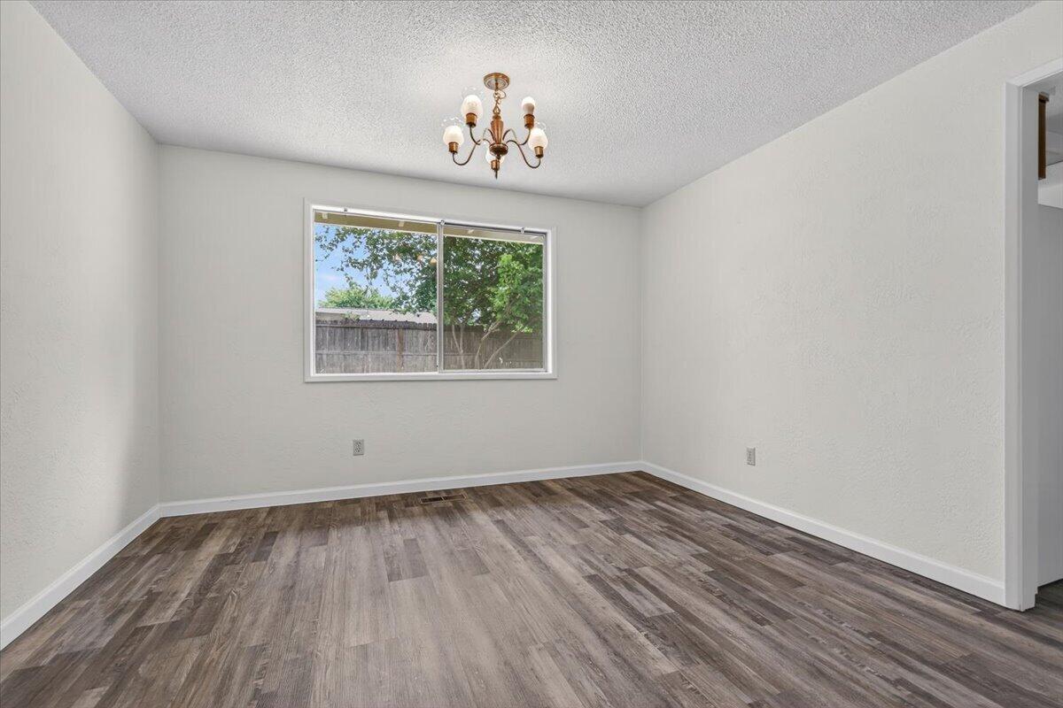 415 Sutter Avenue Medford, OR 97504 - Photo 5 of 28 wooden floor in an empty room with a window