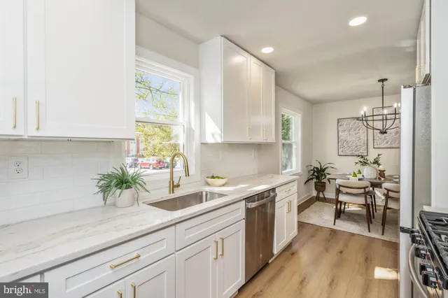 a kitchen with a sink a window and cabinets