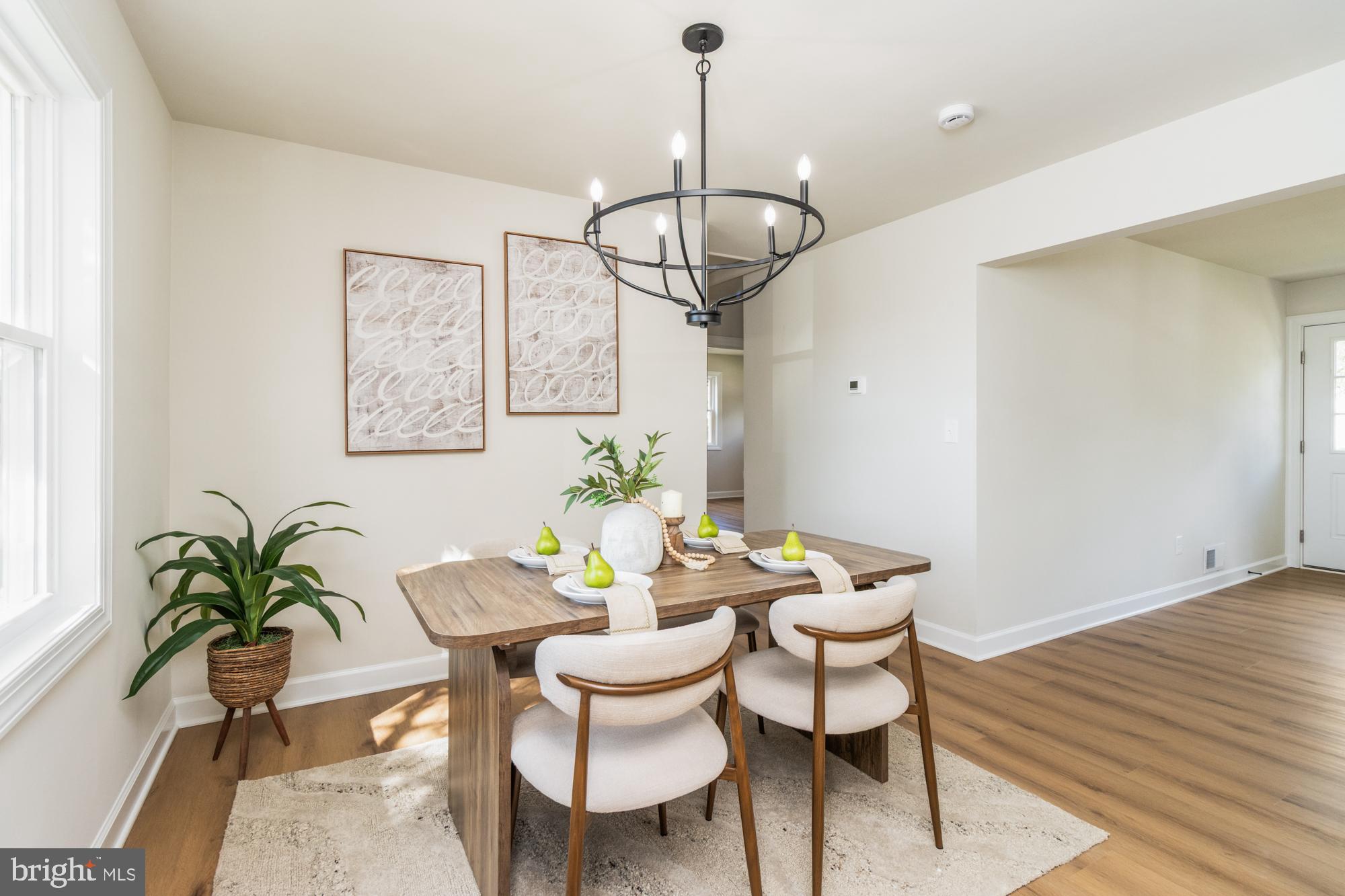 8016 Harris Avenue Parkville, MD 21234 - Photo 12 of 34 a view of a dining room with furniture wooden floor and chandelier