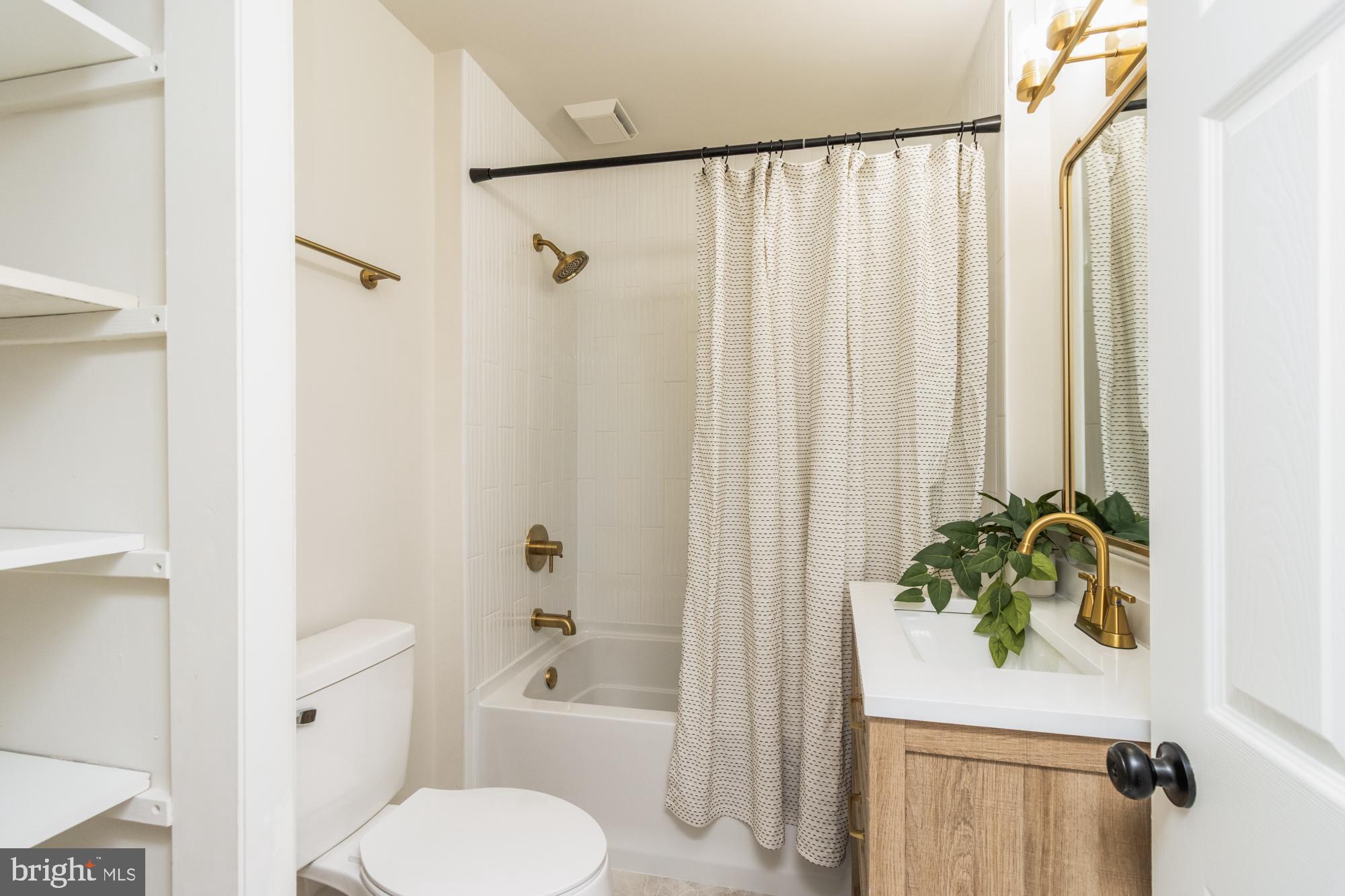 8016 Harris Avenue Parkville, MD 21234 - Photo 13 of 34 a white toilet sitting next to a white tub