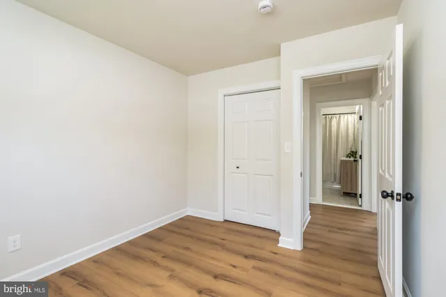 a view of a room with wooden floor and closet