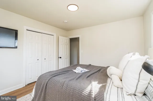 a bedroom with a bed and a lamp