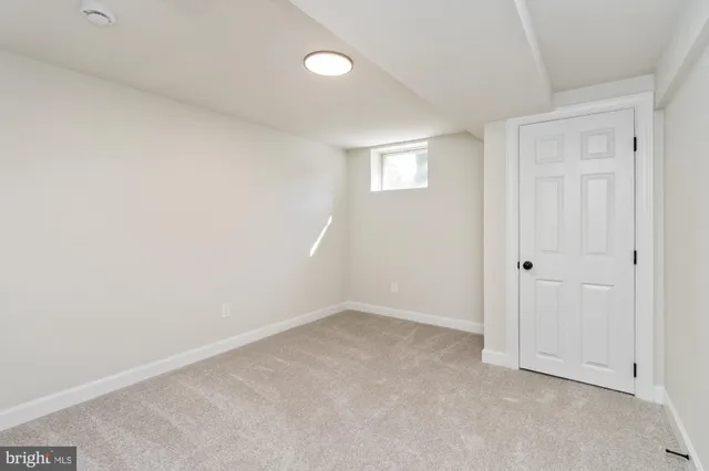 a view of an empty room with closet area