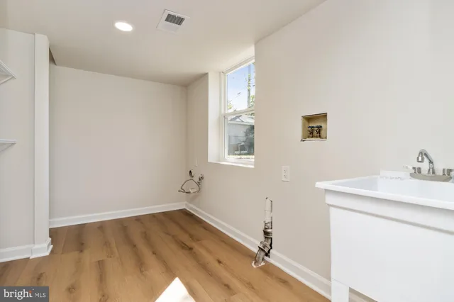 a room with a sink and cabinets